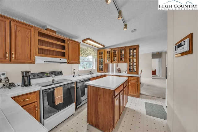 a kitchen with stainless steel appliances granite countertop a stove and a sink