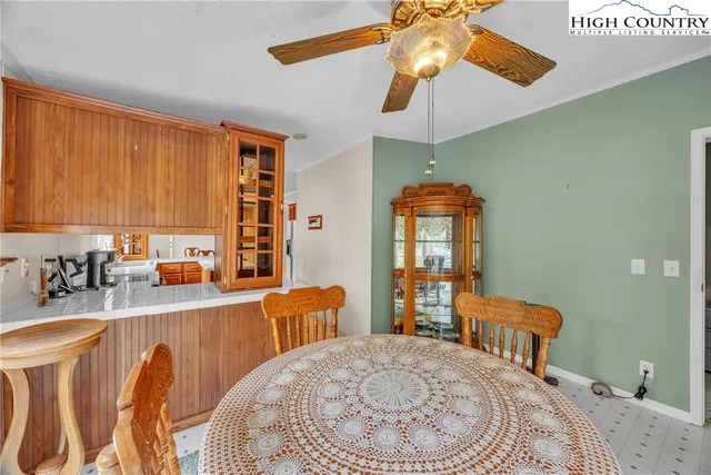 a bedroom with a bed a dresser and chandelier