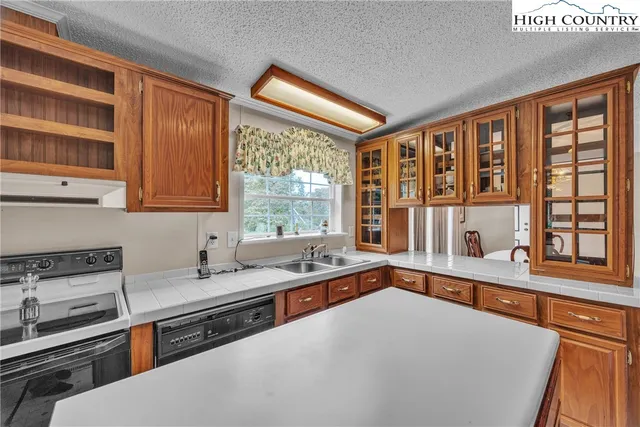 a kitchen that has a sink and a stove