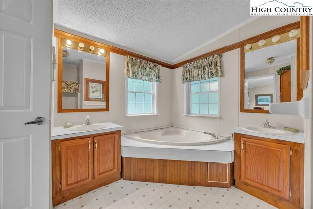 a bathroom with a tub sink and mirror