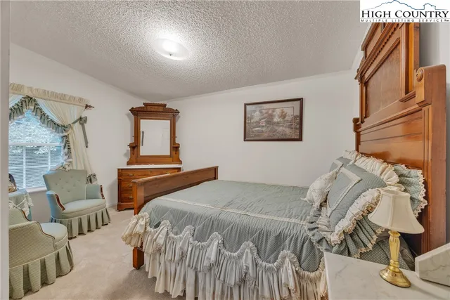 a bedroom with a bed and chair