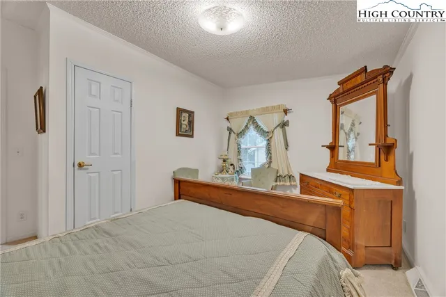 a bedroom with a bed and a mirror