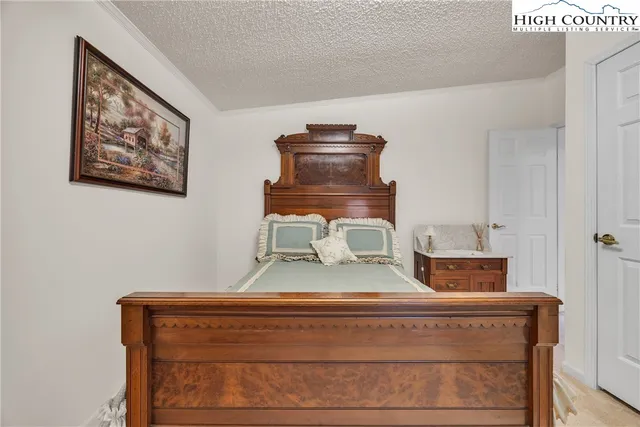 a view of dresser with chair and wooden floor