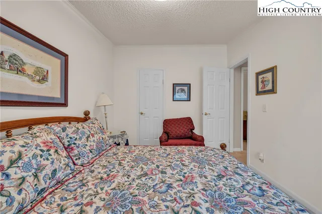 a bedroom with bed and wooden floor
