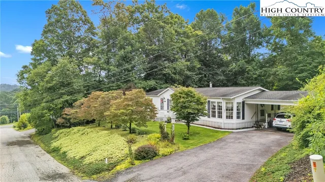 a view of a house with a yard and sitting area