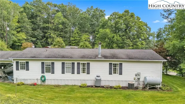 a view of house with backyard