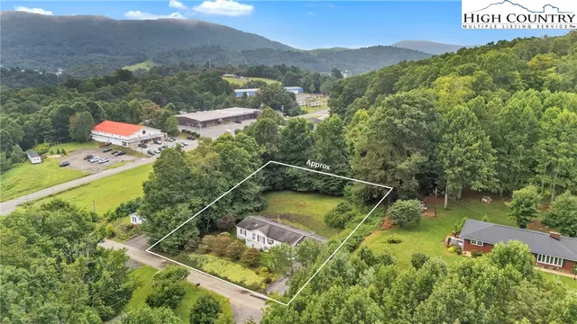 a view of a swimming pool with a yard and mountain view
