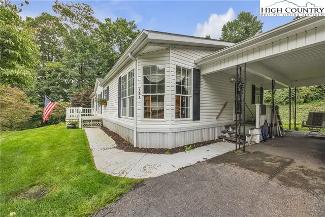 a view of a house with a yard and sitting area