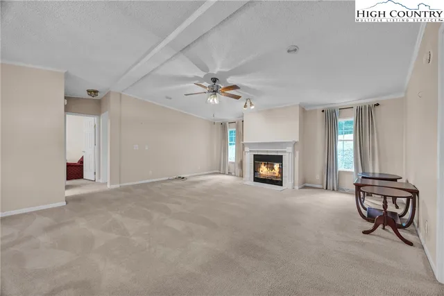 a view of an empty room with a fireplace