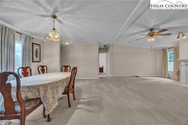 a dining room with furniture and chandelier