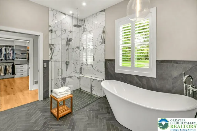 a spacious bathroom with a bathtub shower sink and toilet