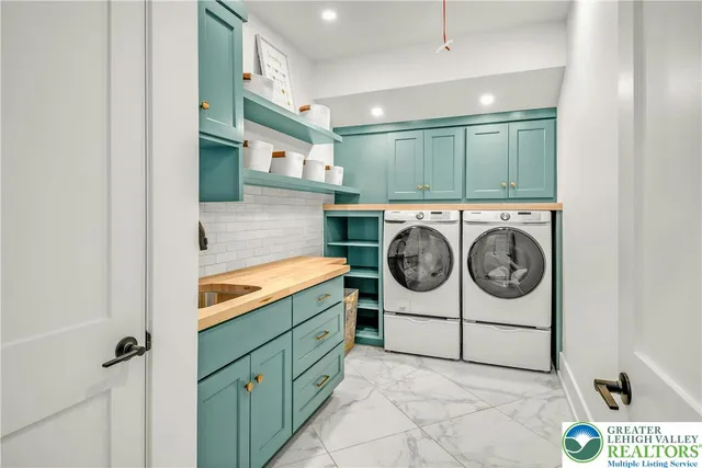 a utility room with sink dryer and washer