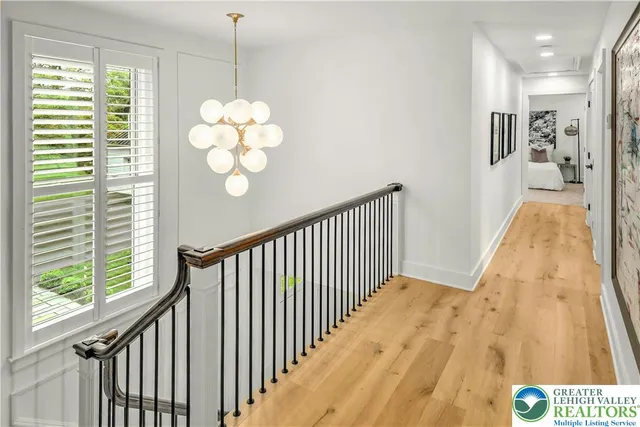 a view of entryway and hall with wooden floor