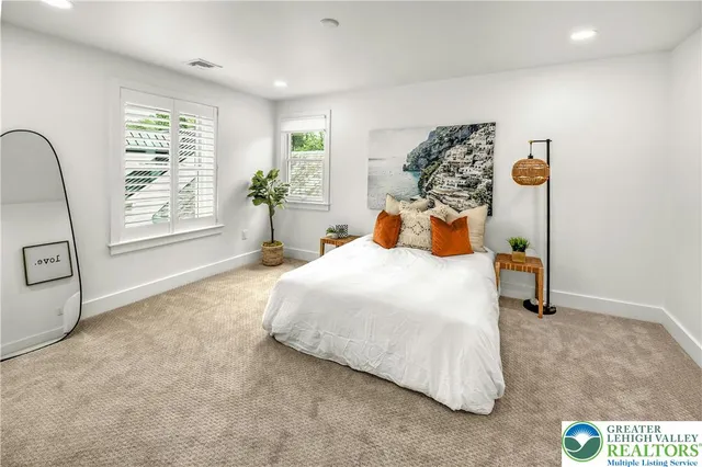 a bedroom with a bed and dresser