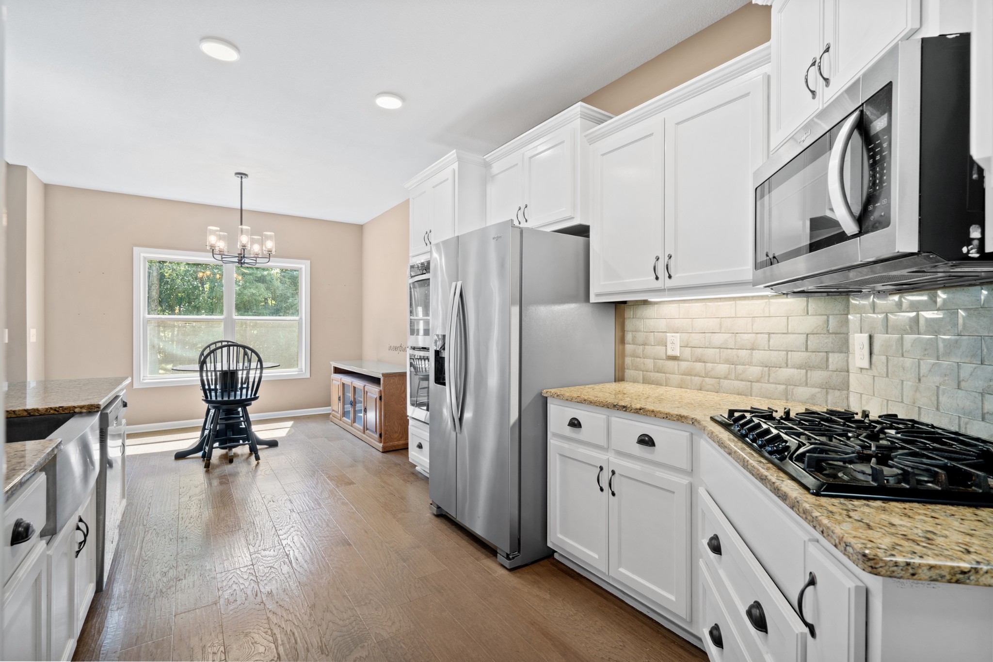 1506 Bend Road Clarksville, TN 37040 - Photo 14 of 56 a kitchen with stainless steel appliances granite countertop a stove a refrigerator a sink dishwasher a oven with white cabinets and wooden floor