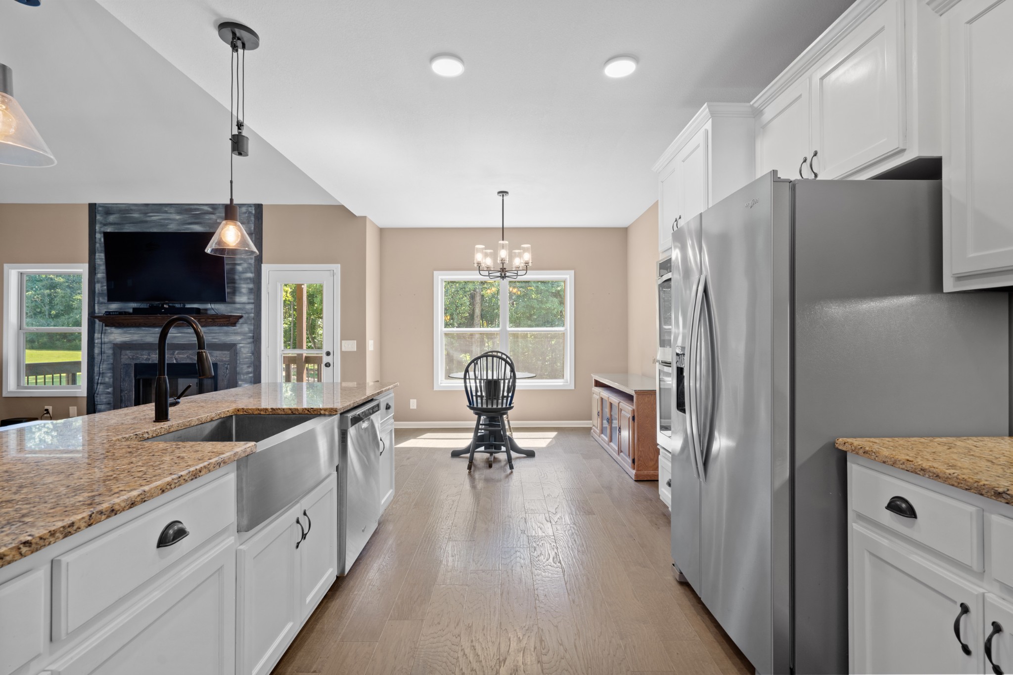 1506 Bend Road Clarksville, TN 37040 - Photo 15 of 56 a large kitchen with stainless steel appliances kitchen island granite countertop a refrigerator oven a sink dishwasher a dining table and chairs with wooden floor