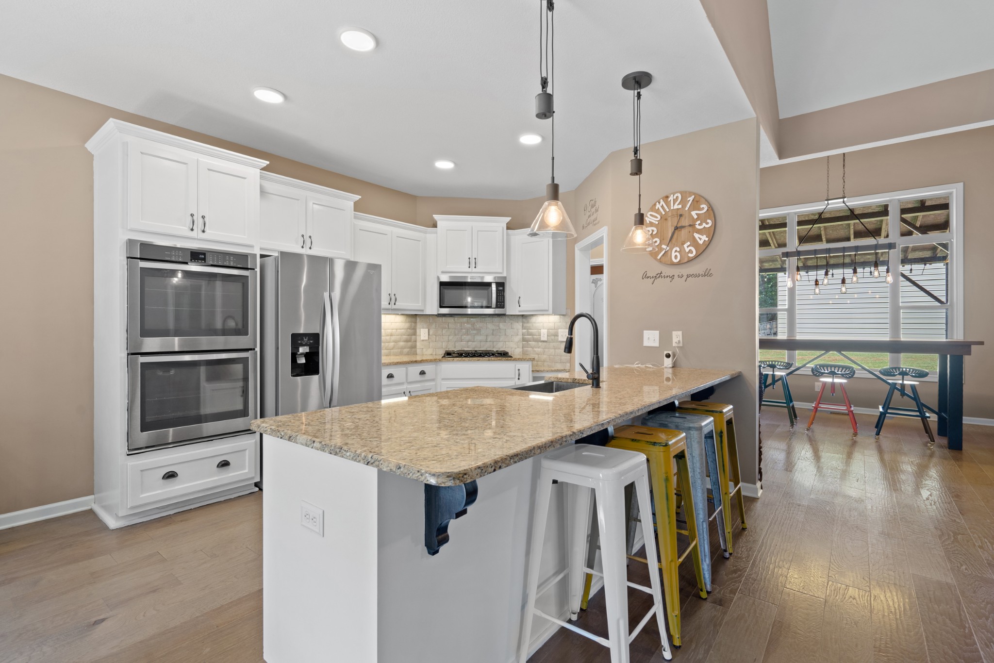1506 Bend Road Clarksville, TN 37040 - Photo 17 of 56 a kitchen with stainless steel appliances kitchen island granite countertop a table chairs and a refrigerator