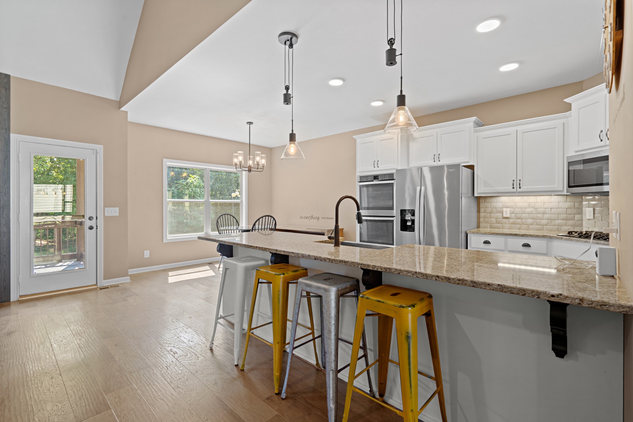 1506 Bend Road Clarksville, TN 37040 - Photo 18 of 56 a kitchen with stainless steel appliances a dining table chairs stove and sink