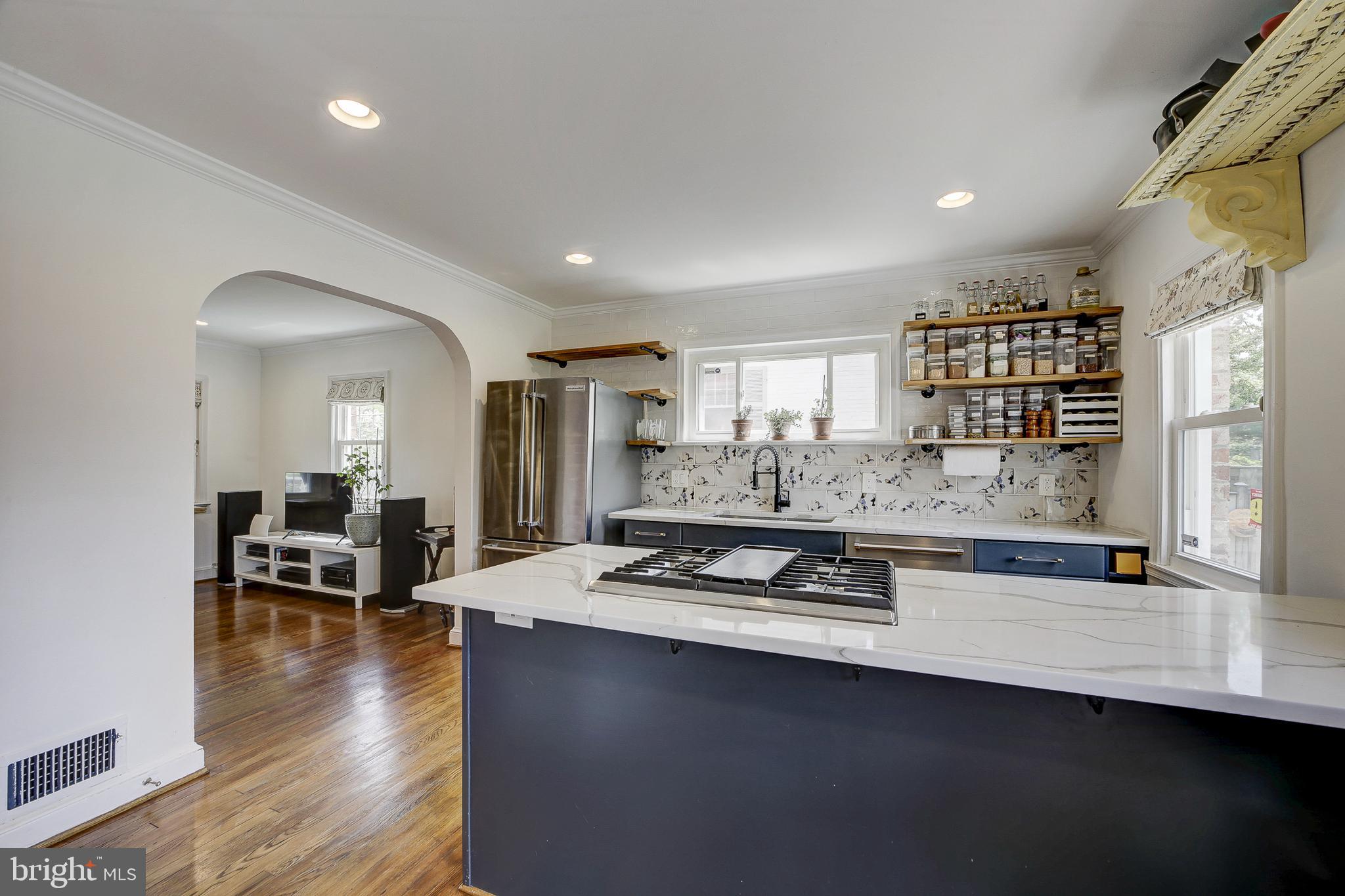 311 Timberwood Avenue Silver Spring, MD 20901 - Photo 12 of 44 a kitchen with stove and wooden floor