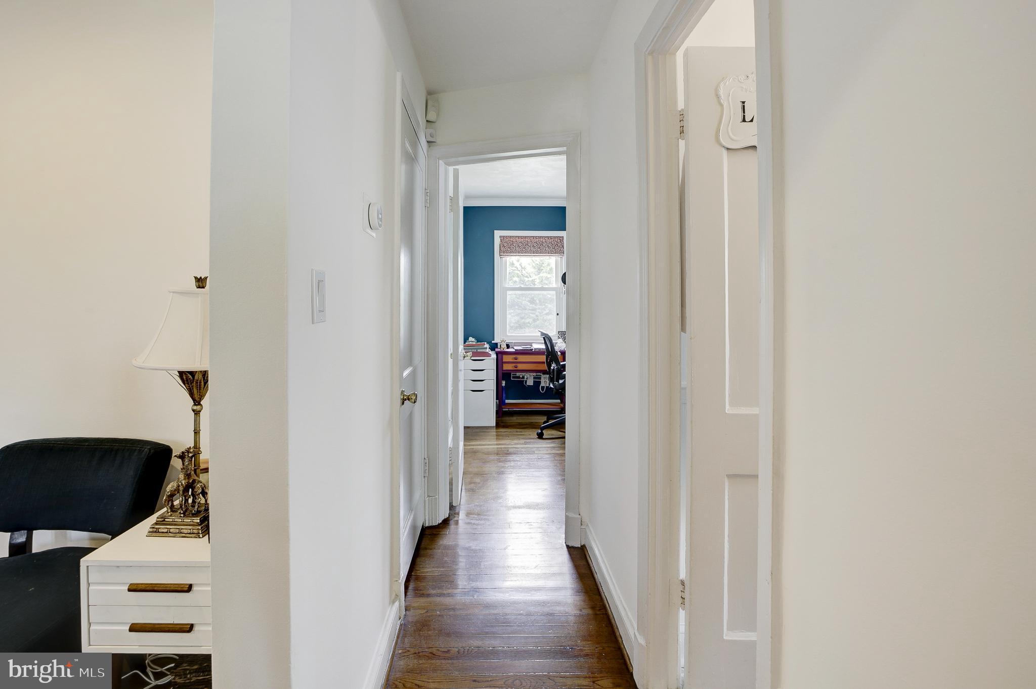 311 Timberwood Avenue Silver Spring, MD 20901 - Photo 19 of 44 a view of a hallway with wooden floor and a living room