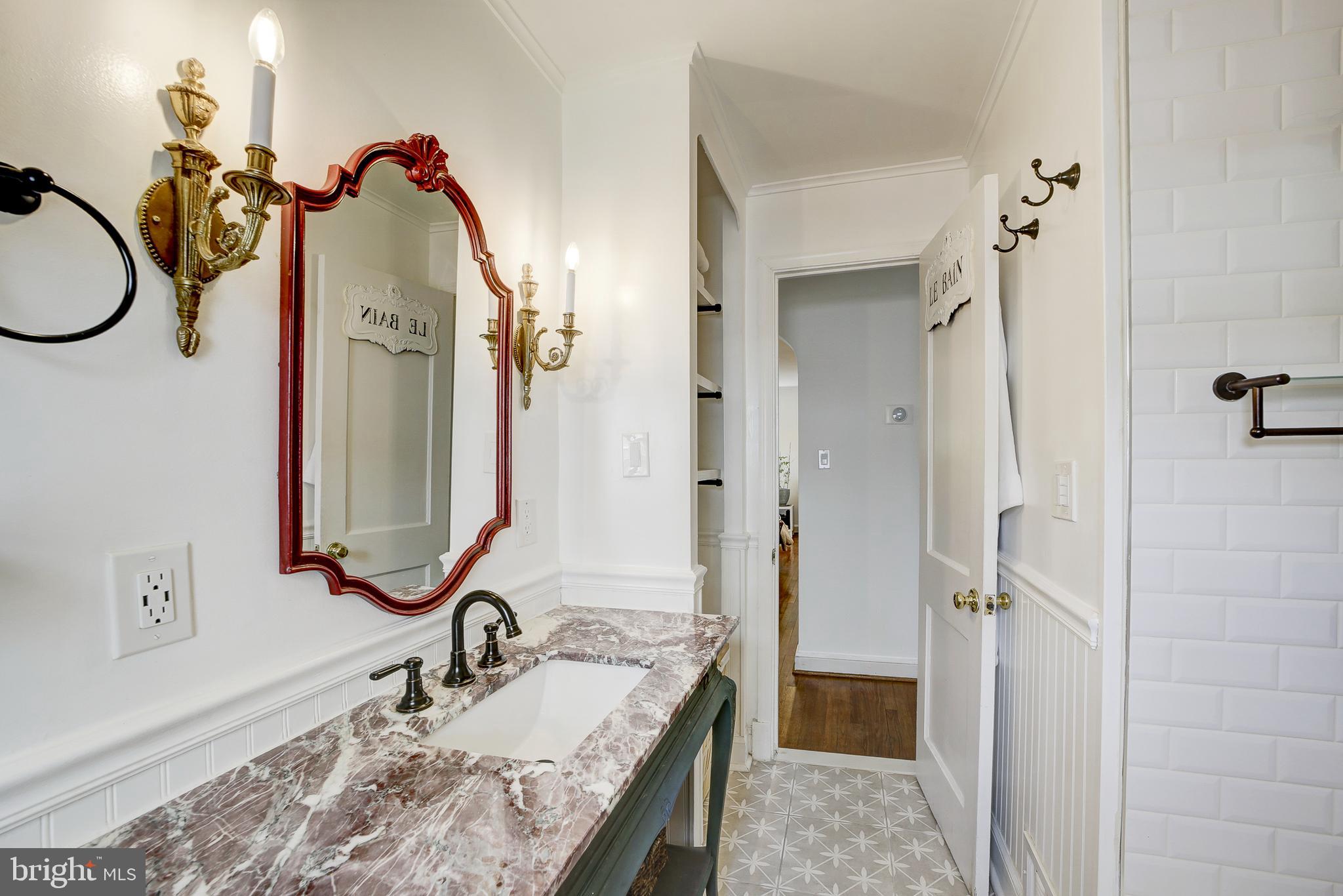 311 Timberwood Avenue Silver Spring, MD 20901 - Photo 25 of 44 a bathroom with a granite countertop sink a mirror a vanity and shower