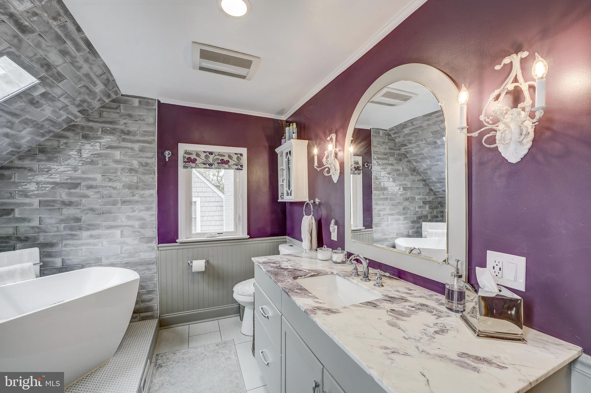 311 Timberwood Avenue Silver Spring, MD 20901 - Photo 30 of 44 a bathroom with a granite countertop sink a toilet a mirror and bathtub
