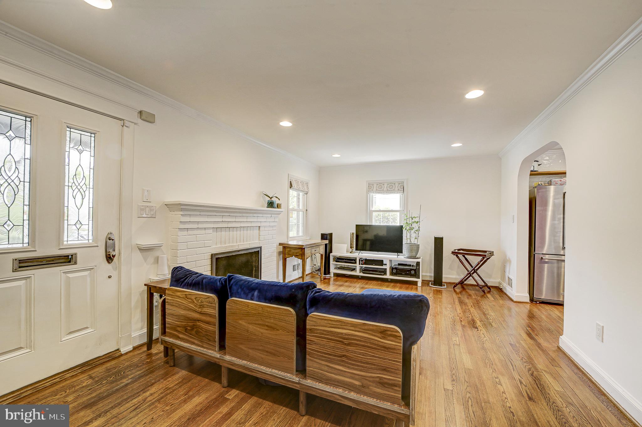311 Timberwood Avenue Silver Spring, MD 20901 - Photo 7 of 44 a living room with furniture a fireplace and wooden floor