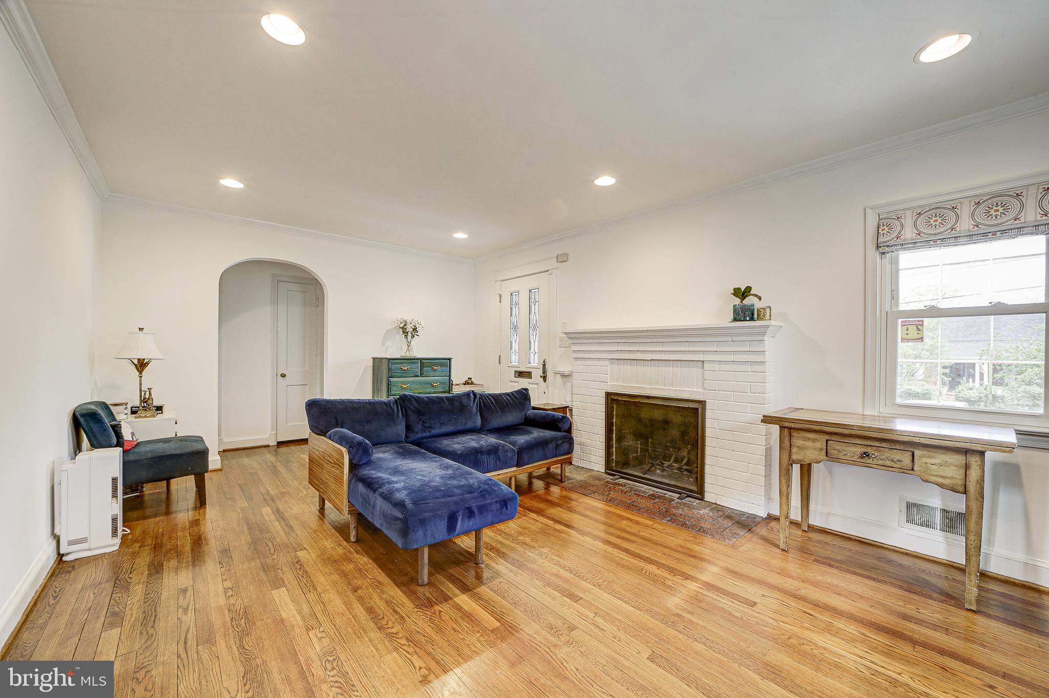 311 Timberwood Avenue Silver Spring, MD 20901 - Photo 8 of 44 a living room with furniture and a fireplace
