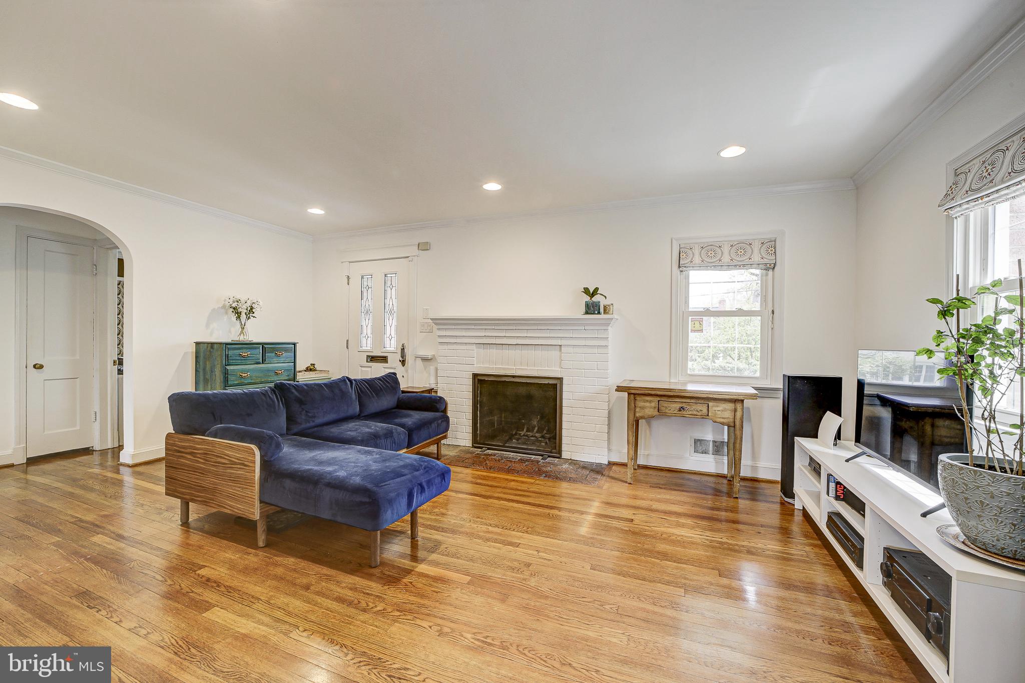 311 Timberwood Avenue Silver Spring, MD 20901 - Photo 9 of 44 a living room with furniture and a fireplace
