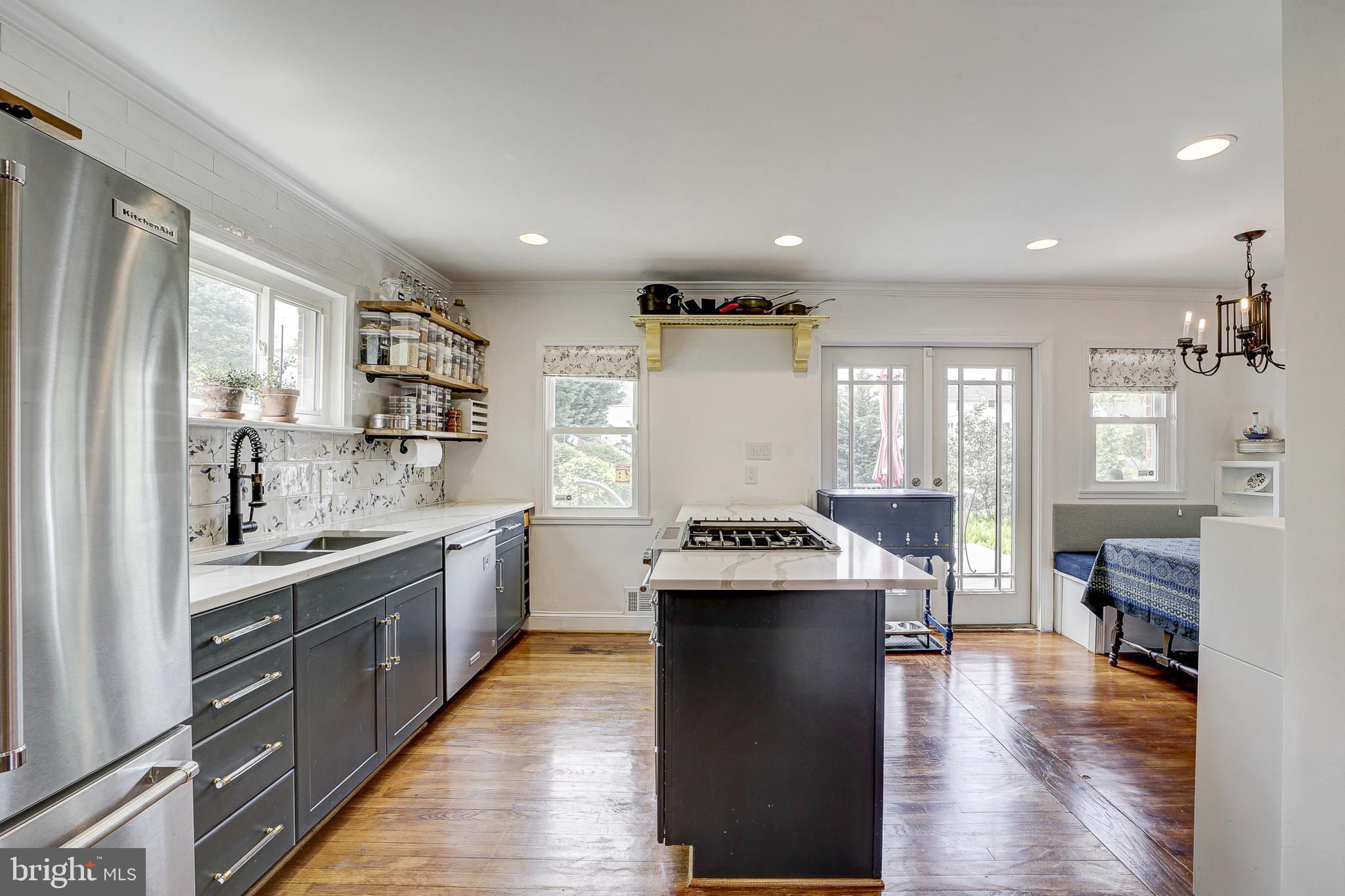 311 Timberwood Avenue Silver Spring, MD 20901 - Photo 10 of 44 a kitchen with stainless steel appliances granite countertop a sink stove and refrigerator