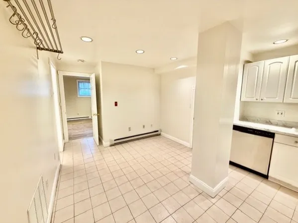 a view of a kitchen with a sink and a refrigerator