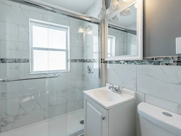 a bathroom with a sink toilet and shower