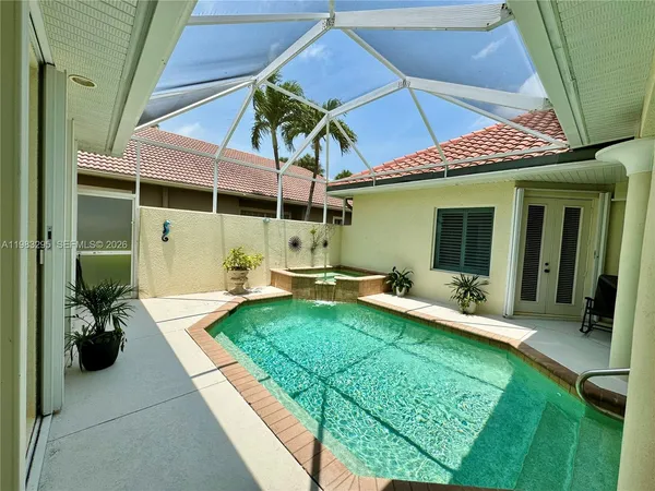 a spacious bedroom with a bed and a flat screen tv