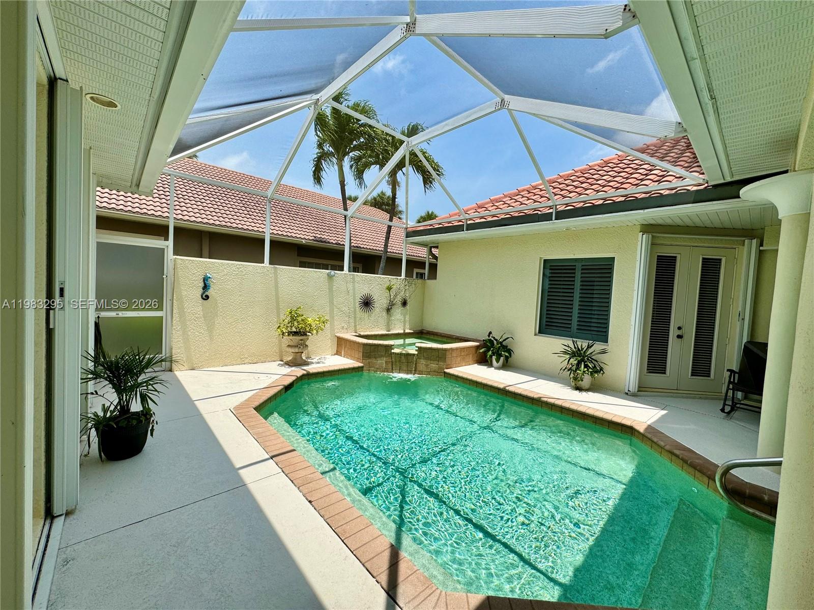 1740 Ludlow Road, Unit 1740 Marco Island, FL 34145 - Photo 11 of 58 a view of a patio with table and chairs under an umbrella