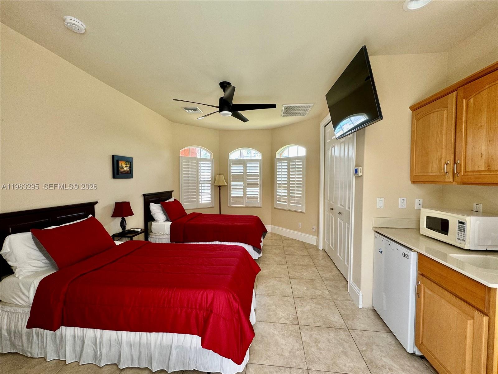 1740 Ludlow Road, Unit 1740 Marco Island, FL 34145 - Photo 14 of 58 a spacious bedroom with a bed and a flat screen tv