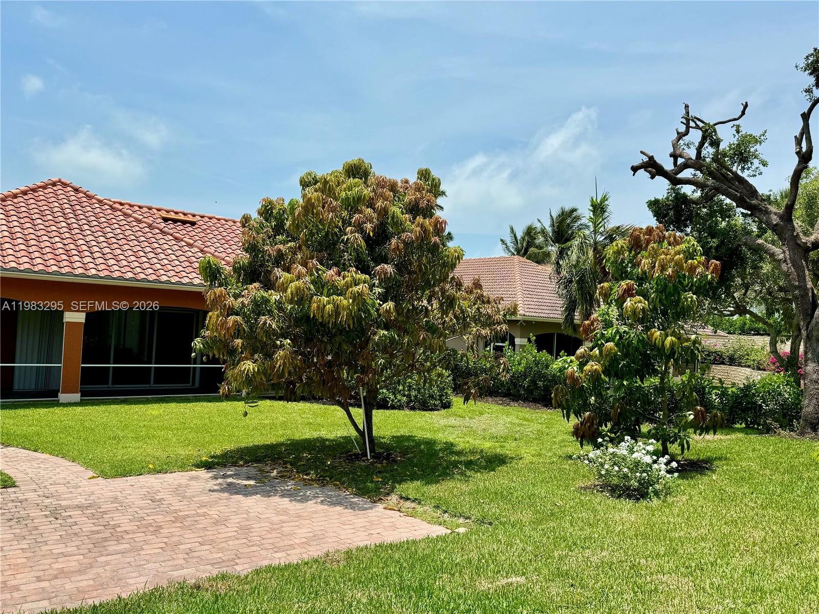 1740 Ludlow Road, Unit 1740 Marco Island, FL 34145 - Photo 2 of 58 a front view of a house with a yard and green space