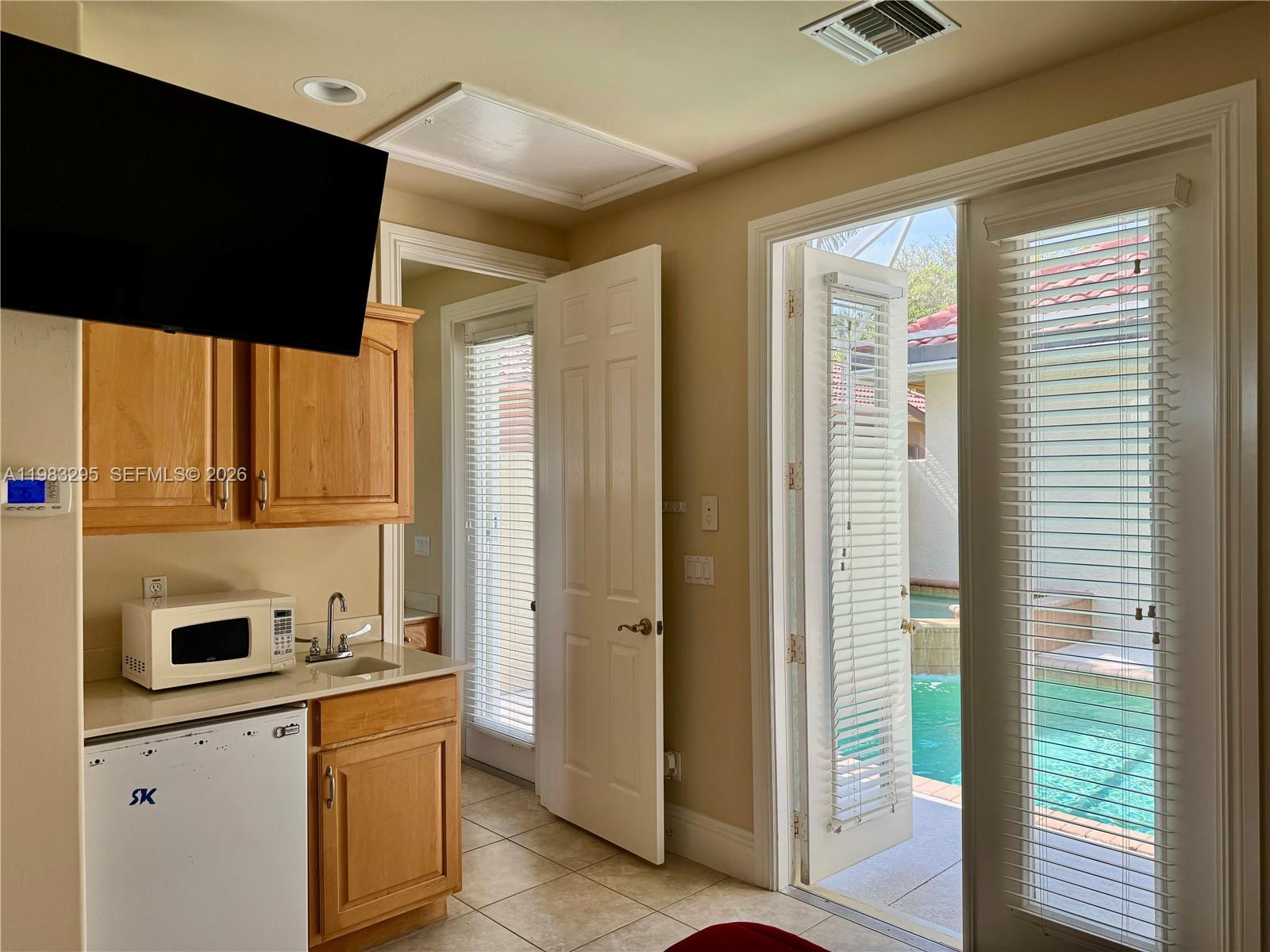 1740 Ludlow Road, Unit 1740 Marco Island, FL 34145 - Photo 21 of 58 a kitchen with stainless steel appliances granite countertop a refrigerator and a sink