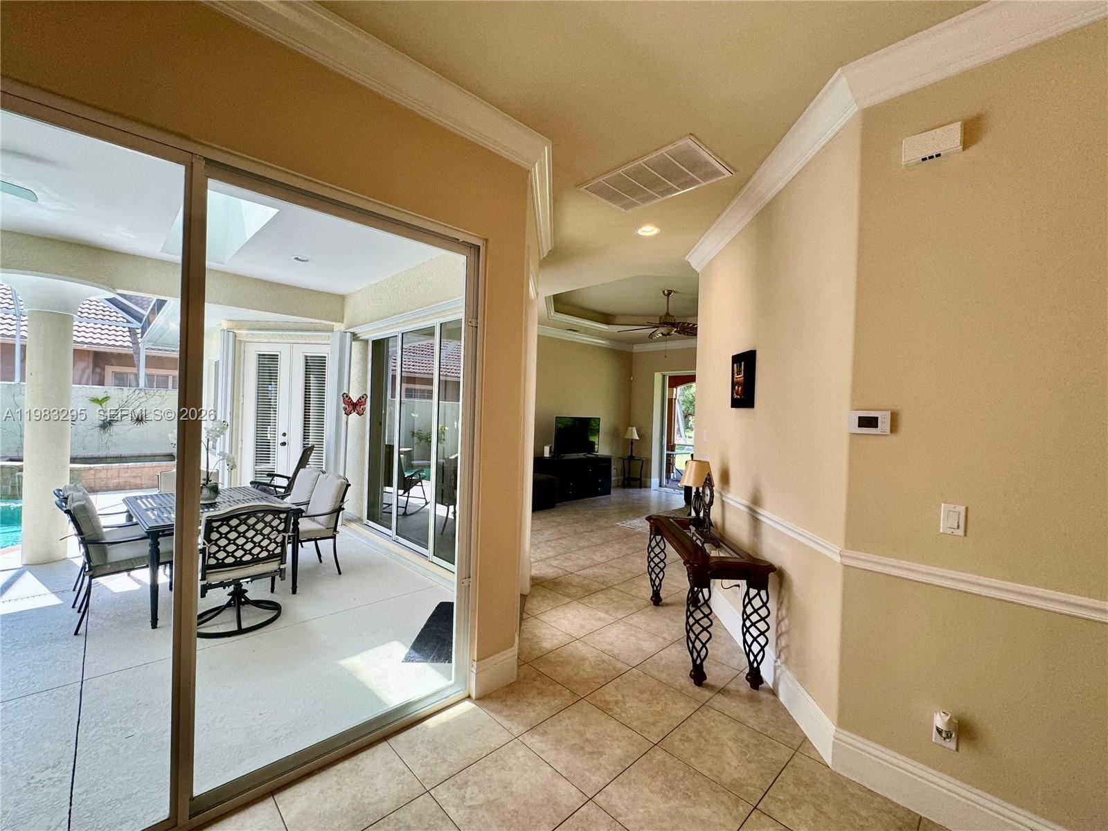 1740 Ludlow Road, Unit 1740 Marco Island, FL 34145 - Photo 23 of 58 a view of a hallway with dining area and glass door