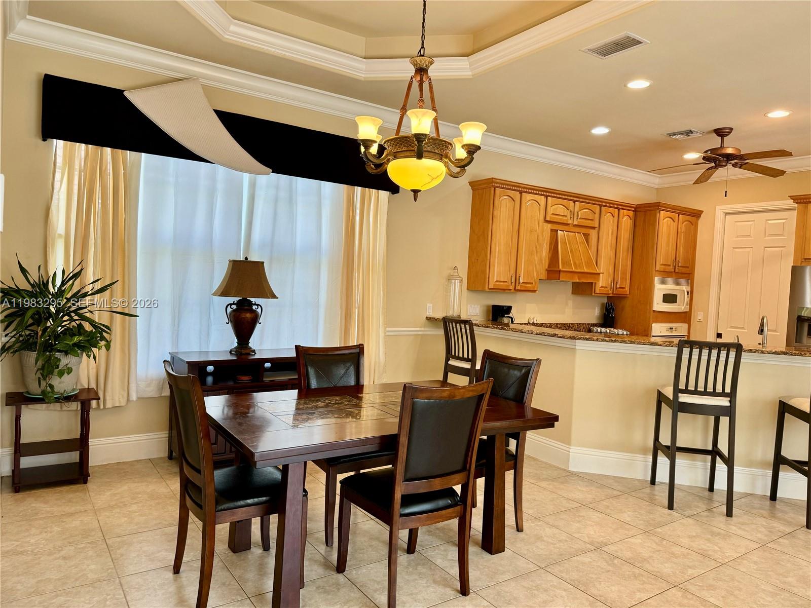 1740 Ludlow Road, Unit 1740 Marco Island, FL 34145 - Photo 28 of 58 a dining room filled chandelier and wooden floor