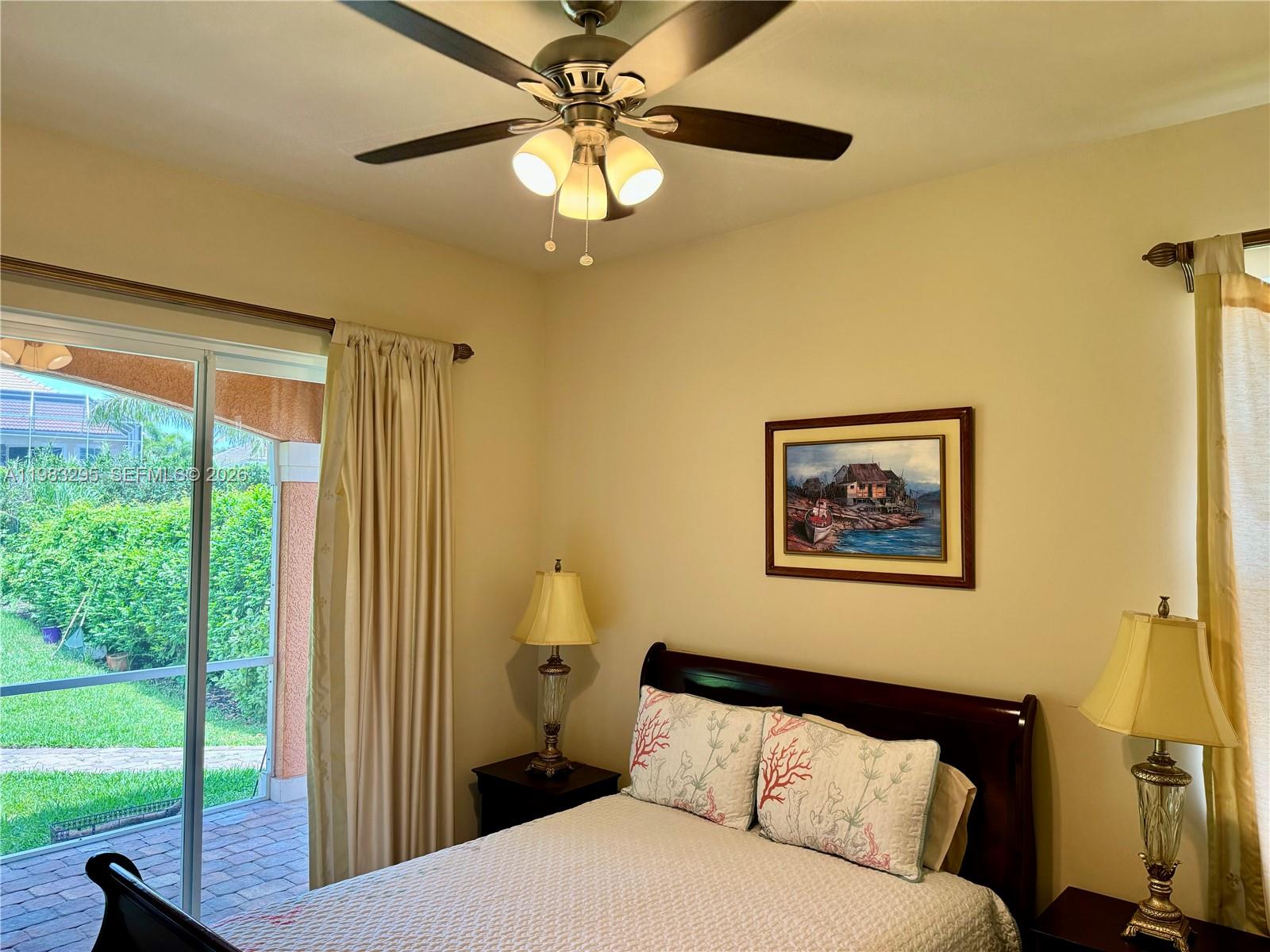 1740 Ludlow Road, Unit 1740 Marco Island, FL 34145 - Photo 39 of 58 a bedroom with a large bed and a chandelier