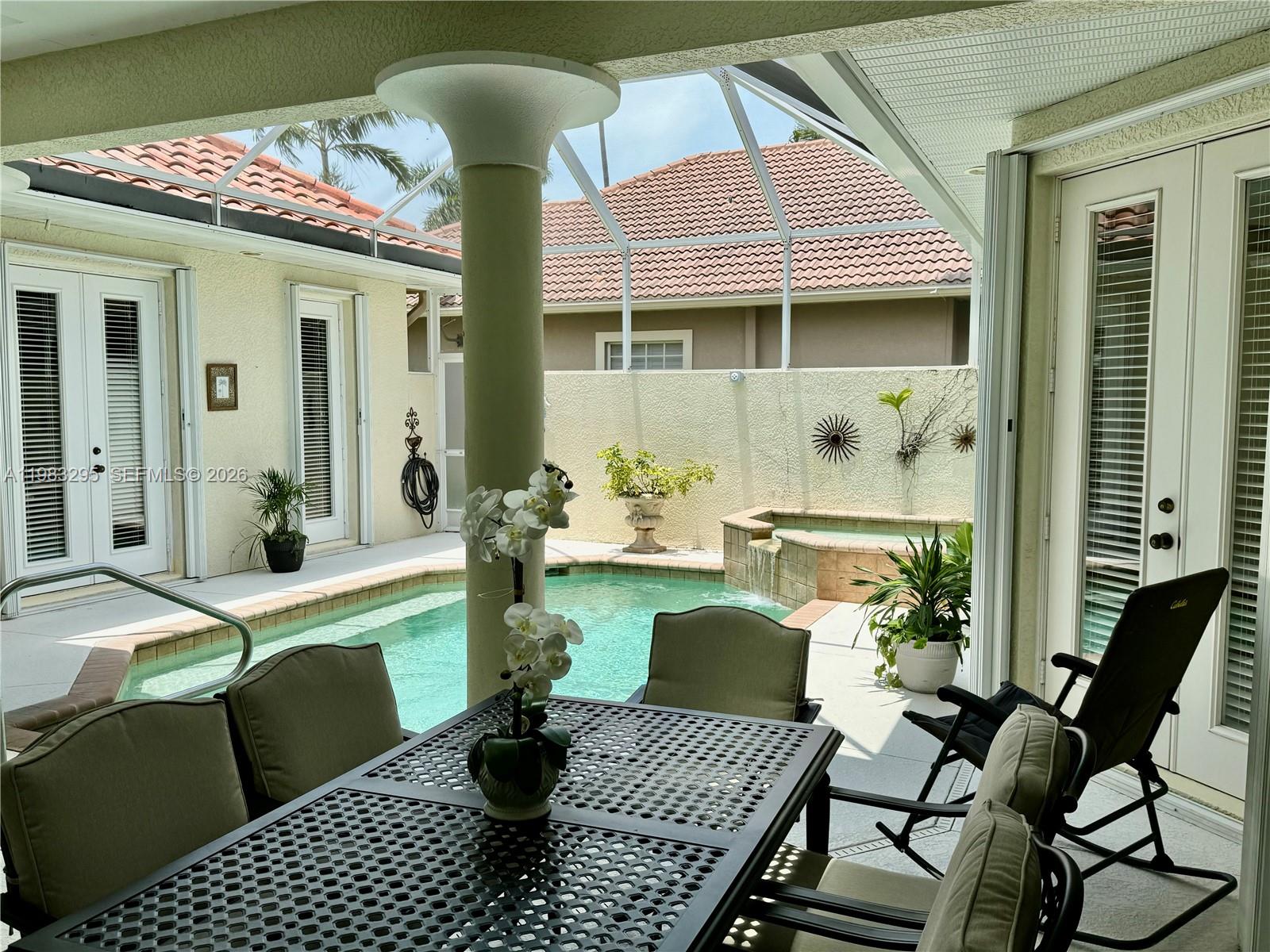 1740 Ludlow Road, Unit 1740 Marco Island, FL 34145 - Photo 9 of 58 a view of a patio with table and chairs