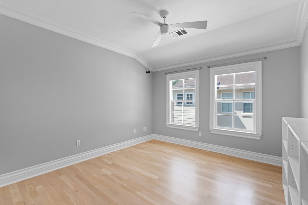 1609 Hartford Road, Unit A Austin, TX 78703 - Photo 32 of 39 Natural light bathes this bedroom, illuminating the gleaming hardwood flooring and crisp crown molding.