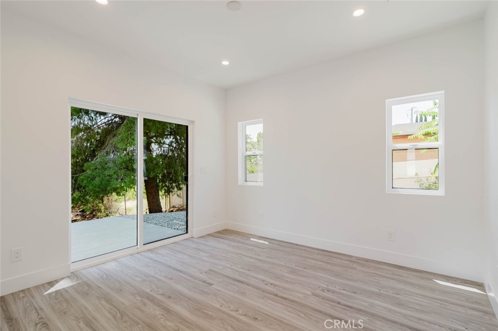 17846 Rinaldi Street Granada Hills, CA 91344 - Photo 7 of 34 a view of an empty room with wooden floor and a window