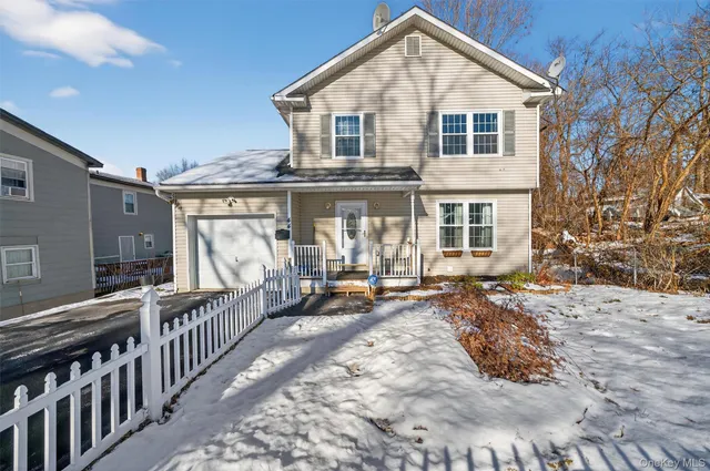 a view of a house with backyard porch and wooden fence