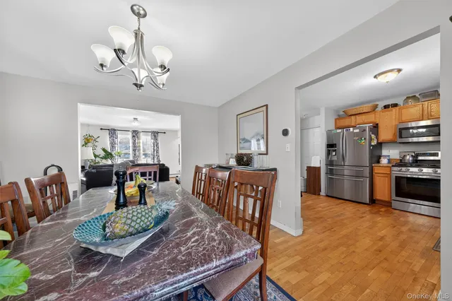 a living room with furniture and a dining table