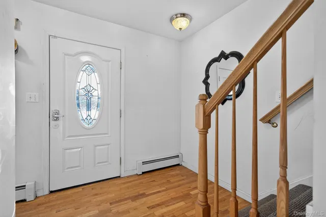 a view of an entryway with wooden floor