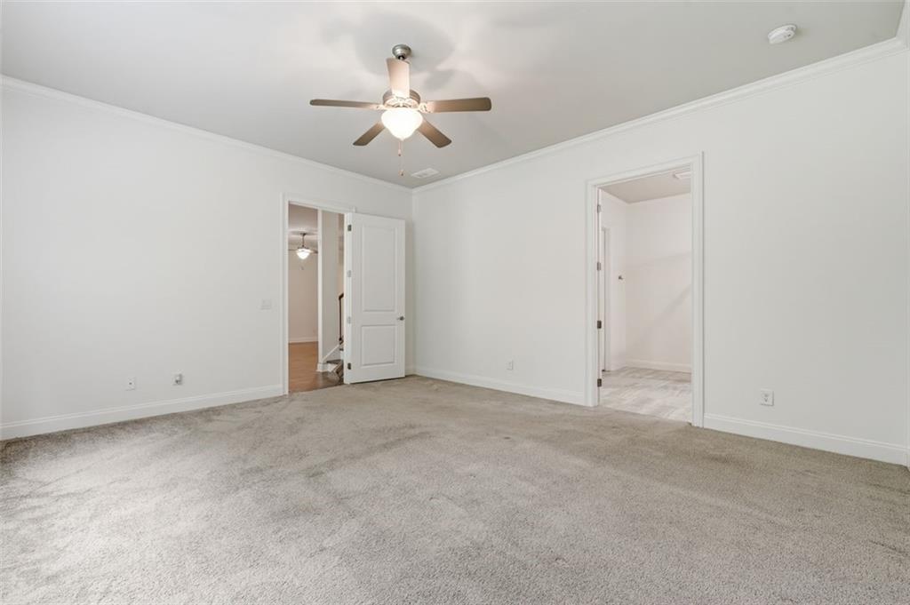 337 Rosshandler Road Suwanee, GA 30024 - Photo 35 of 45 an empty room with a chandelier fan and windows