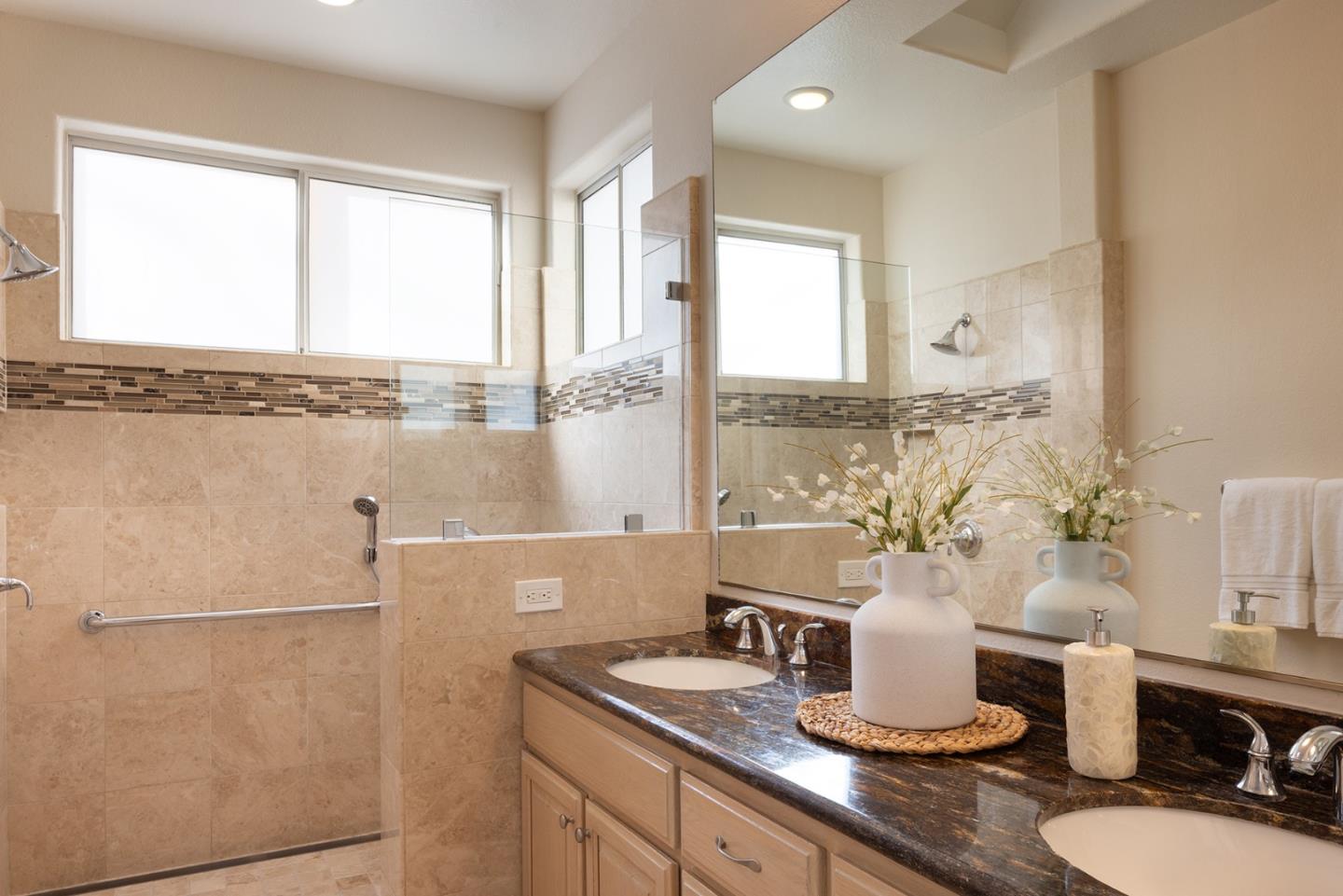 17776 Riverbend Road Salinas, CA 93908 - Photo 13 of 22 a bathroom with a granite countertop sink toilet a mirror and a tub