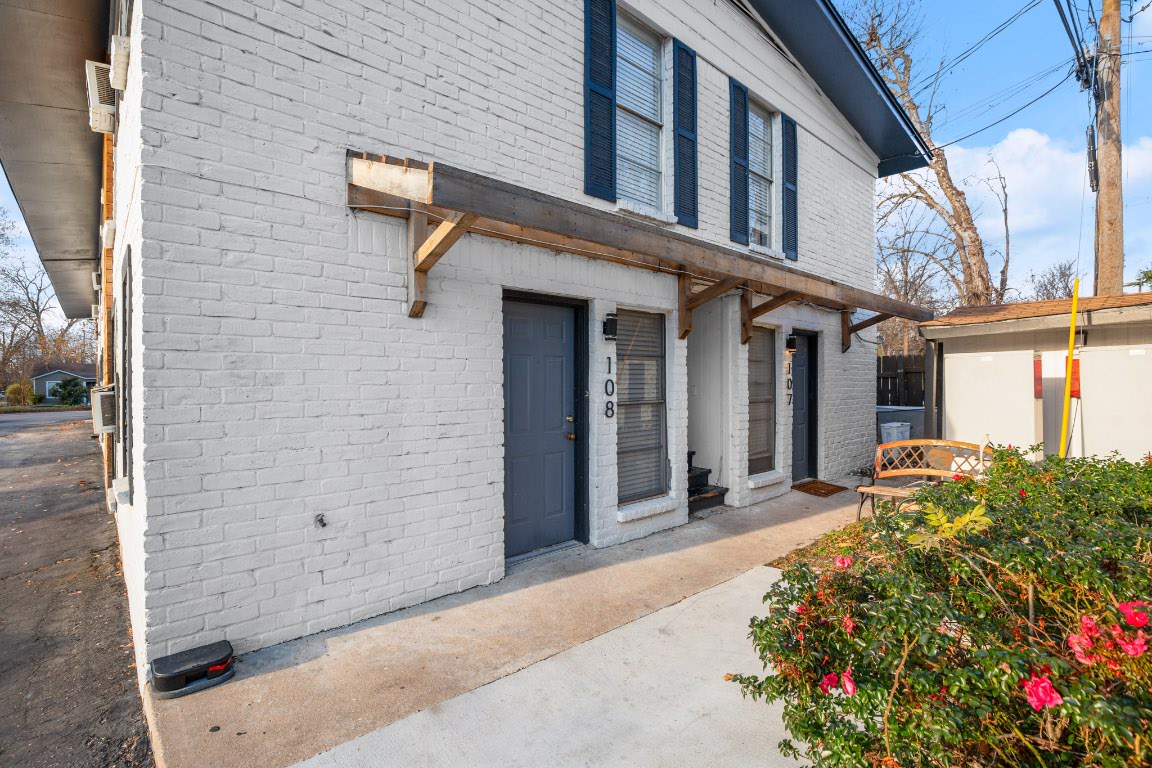 5300 Guadalupe Street, Unit 108 Austin, TX 78751 - Photo 1 of 11 a view of a brick house with potted plants