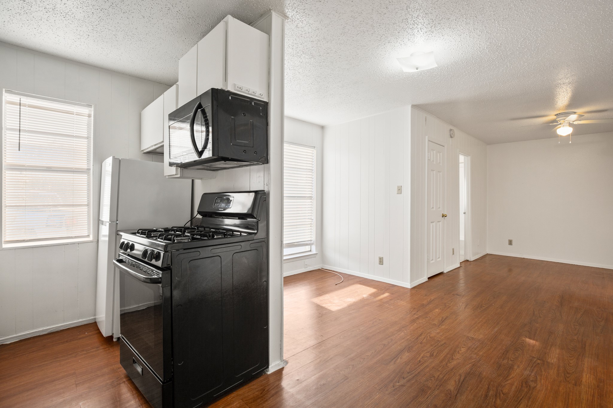 5300 Guadalupe Street, Unit 108 Austin, TX 78751 - Photo 2 of 11 a kitchen with stainless steel appliances granite countertop a stove and a refrigerator